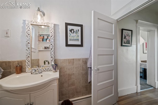 bathroom with vanity, tile walls, and hardwood / wood-style flooring