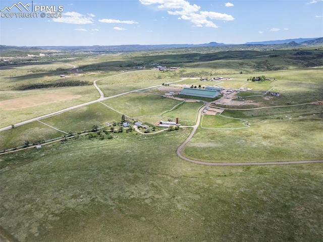 birds eye view of property with a mountain view and a rural view