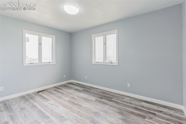 spare room with light hardwood / wood-style floors