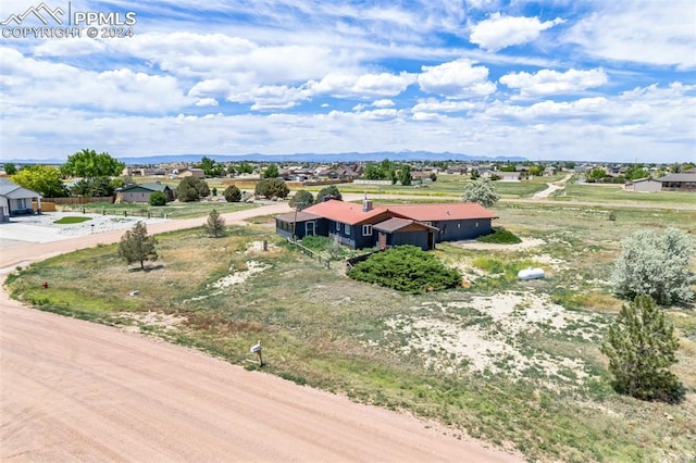 drone / aerial view with a mountain view and a rural view