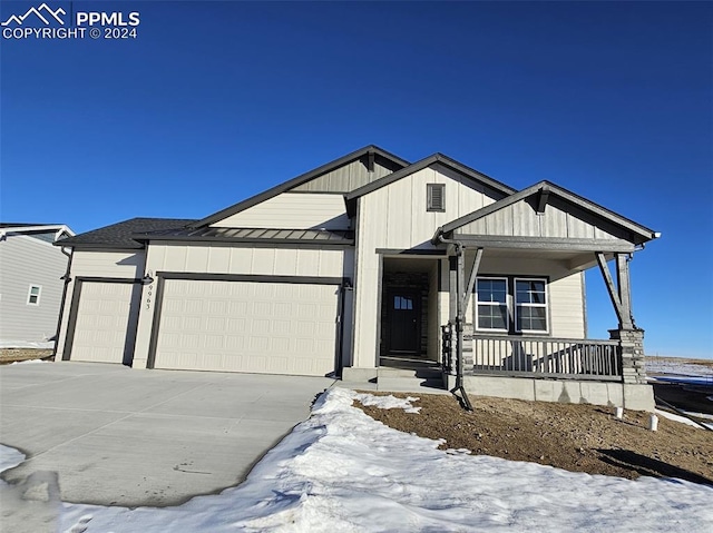 view of front of property with a garage and covered porch