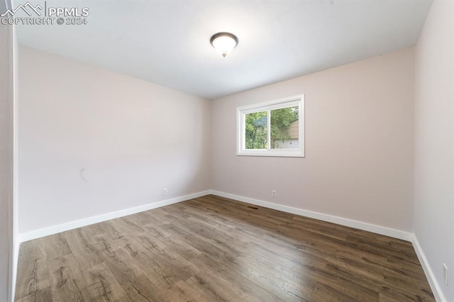 spare room with wood-type flooring