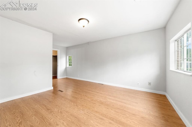 spare room featuring light wood-type flooring