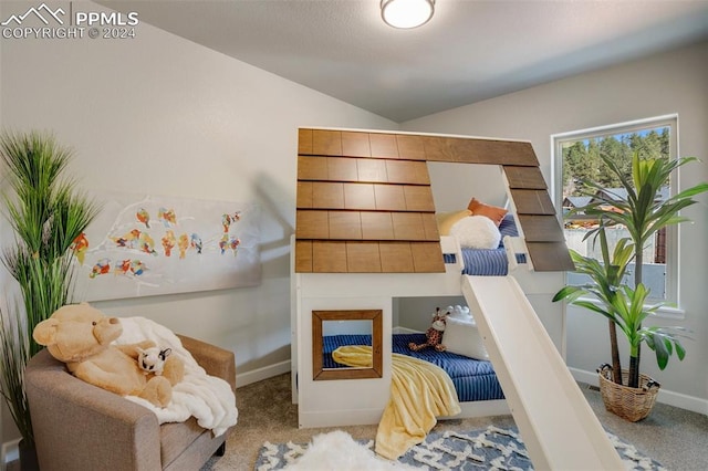 carpeted bedroom with lofted ceiling