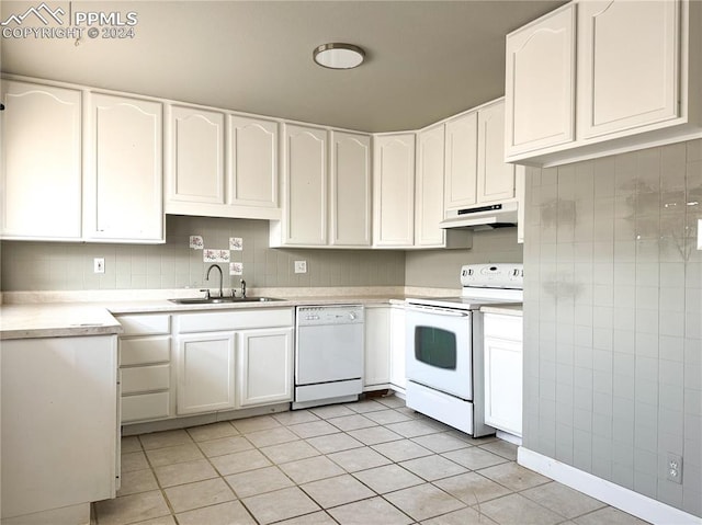 kitchen featuring white appliances, sink, white cabinetry, and light tile floors