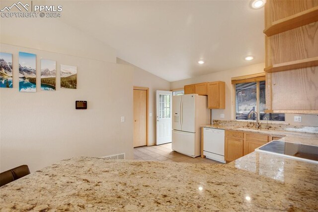 kitchen with lofted ceiling, light brown cabinetry, sink, light tile patterned floors, and white appliances