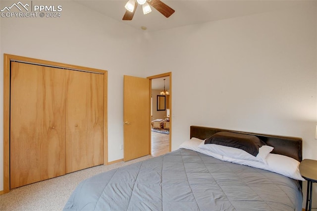 carpeted bedroom with ceiling fan and a closet