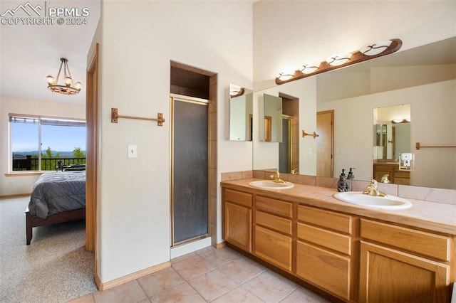 bathroom with vanity, tile patterned floors, a shower with door, and a chandelier