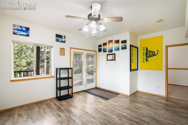 interior space with wood-type flooring and ceiling fan