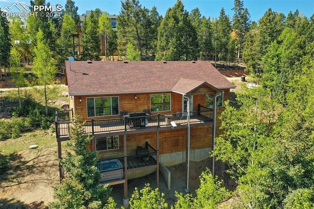 rear view of house featuring a deck