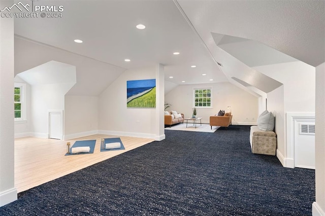 interior space featuring carpet floors and lofted ceiling