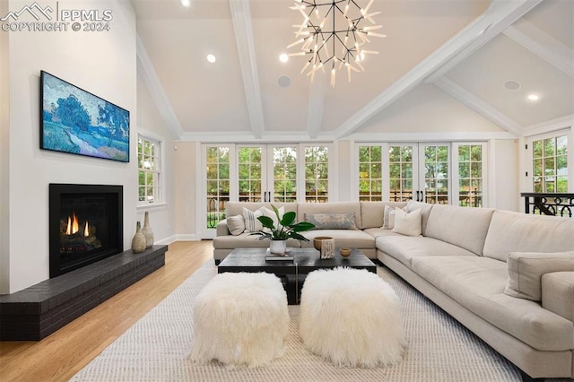 sunroom featuring lofted ceiling with beams, a brick fireplace, and plenty of natural light