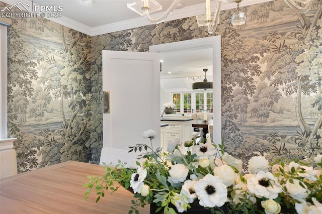 interior space with a chandelier and crown molding