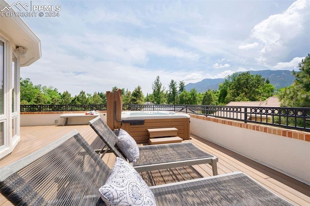 view of patio / terrace with a mountain view and a hot tub