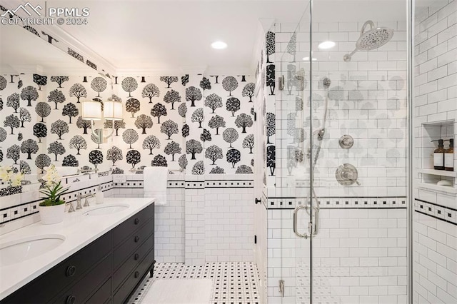 bathroom with vanity, an enclosed shower, ornamental molding, and tile walls