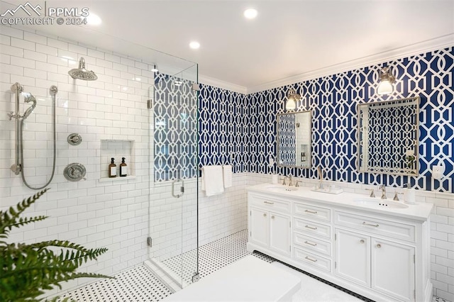 bathroom featuring vanity, an enclosed shower, ornamental molding, and tile walls