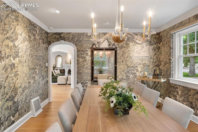 bedroom with a multi sided fireplace, ceiling fan, wood-type flooring, and a wall of windows