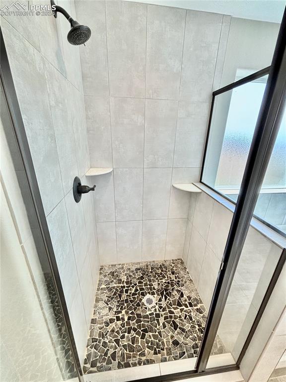 bathroom with tiled shower