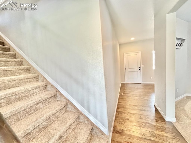 stairway featuring hardwood / wood-style flooring