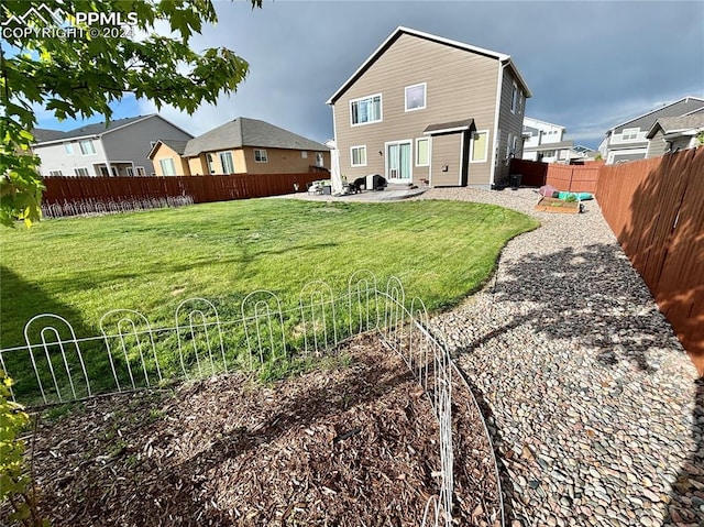 rear view of property featuring a patio and a yard