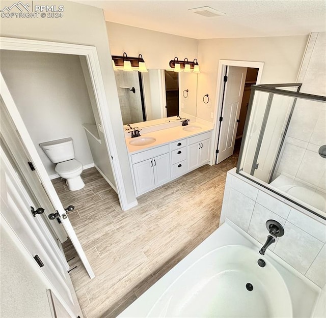 bathroom featuring dual vanity and plus walk in shower