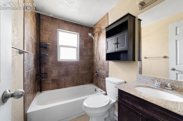 full bathroom featuring tile patterned flooring, vanity, tiled shower / bath combo, and toilet