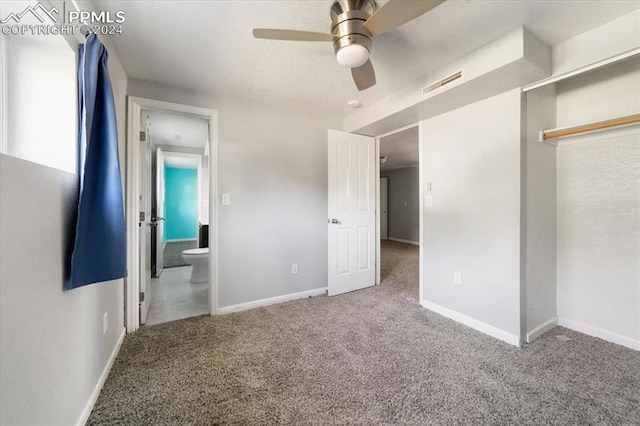 unfurnished bedroom featuring connected bathroom, ceiling fan, a closet, and carpet floors