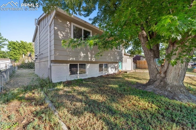 rear view of property with a yard