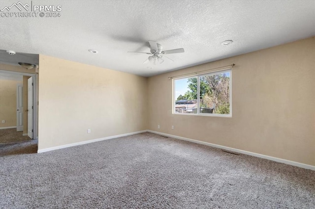 carpeted empty room with a textured ceiling and ceiling fan