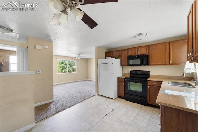 kitchen featuring black appliances, sink, ceiling fan, a textured ceiling, and light colored carpet