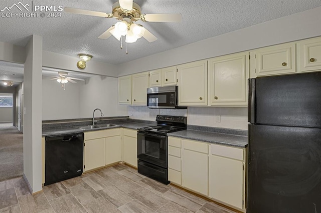 kitchen with cream cabinetry, sink, a textured ceiling, and black appliances