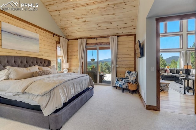 carpeted bedroom featuring access to outside, wooden ceiling, high vaulted ceiling, and wooden walls