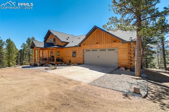 log cabin featuring a garage