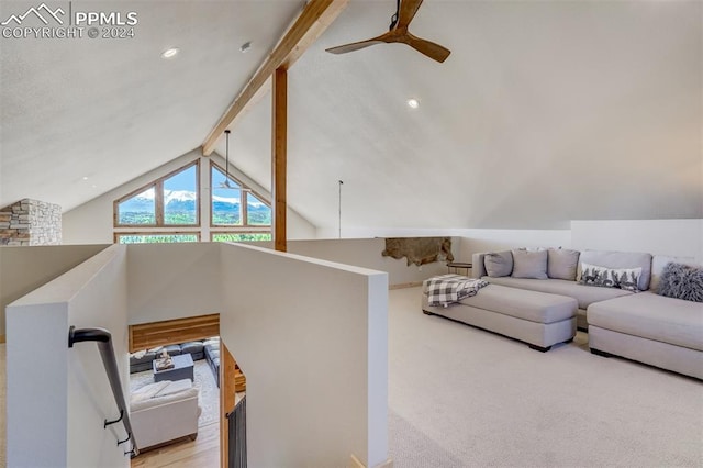 carpeted living room with brick wall, lofted ceiling with beams, and ceiling fan