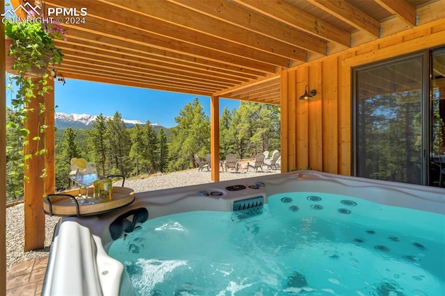 view of swimming pool featuring a patio area and a hot tub