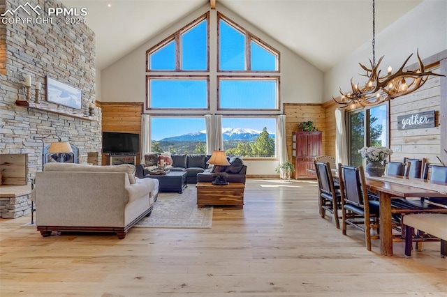 living room featuring high vaulted ceiling, a wealth of natural light, and hardwood / wood-style floors