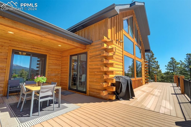 wooden terrace featuring a grill