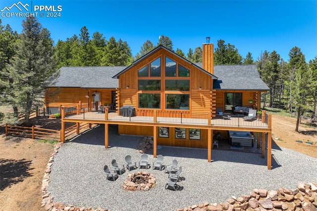 rear view of property with a wooden deck