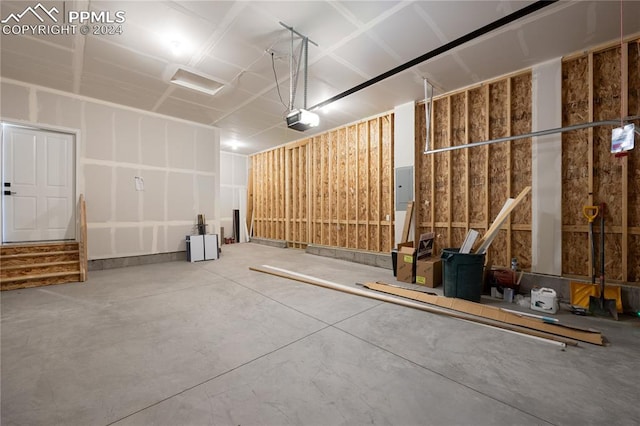 garage featuring a garage door opener and electric panel