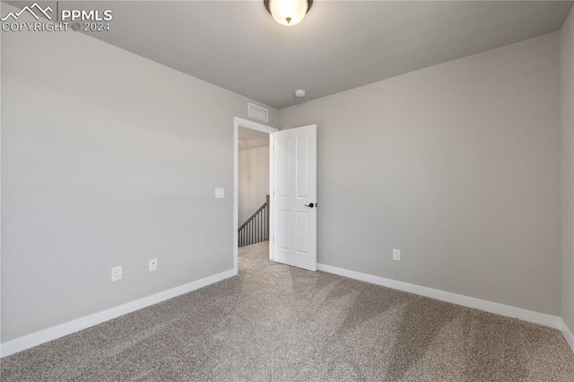 unfurnished room featuring carpet flooring