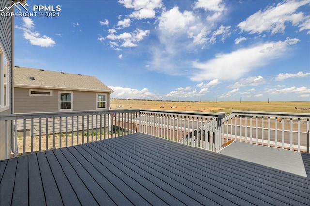 wooden deck featuring a rural view