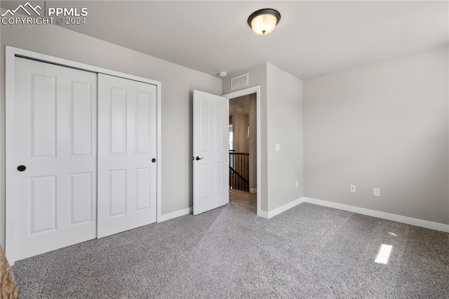 unfurnished bedroom featuring a closet and carpet