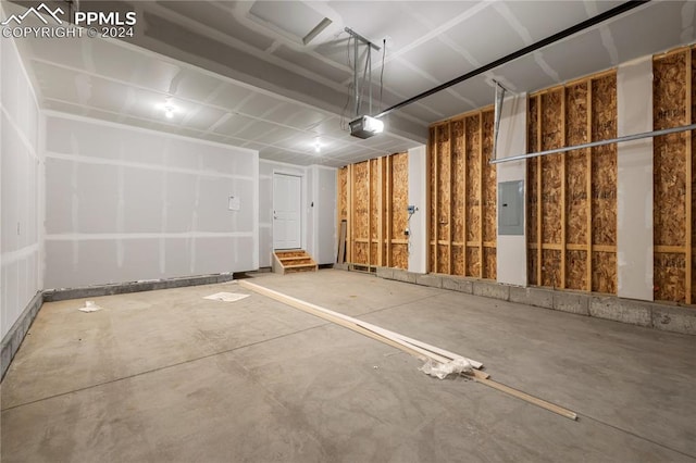 garage featuring electric panel and a garage door opener