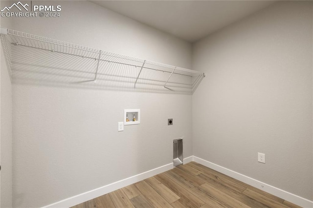 clothes washing area featuring hookup for a washing machine, wood-type flooring, and electric dryer hookup