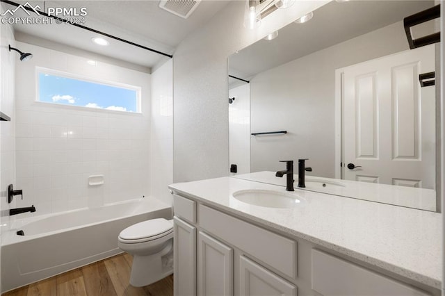 full bathroom featuring vanity, toilet, wood-type flooring, and shower / washtub combination