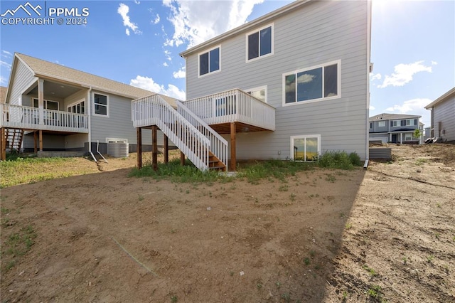 rear view of house featuring a deck and central AC