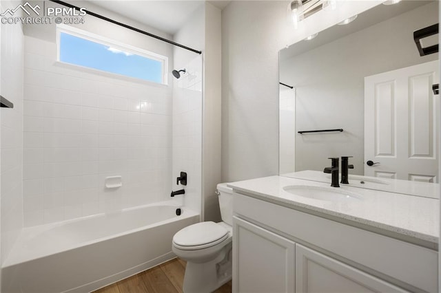 full bathroom featuring vanity, shower / bath combination, toilet, and hardwood / wood-style floors