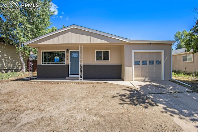 view of front facade featuring a garage and covered porch