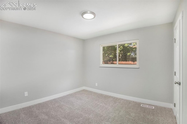 unfurnished room featuring carpet flooring