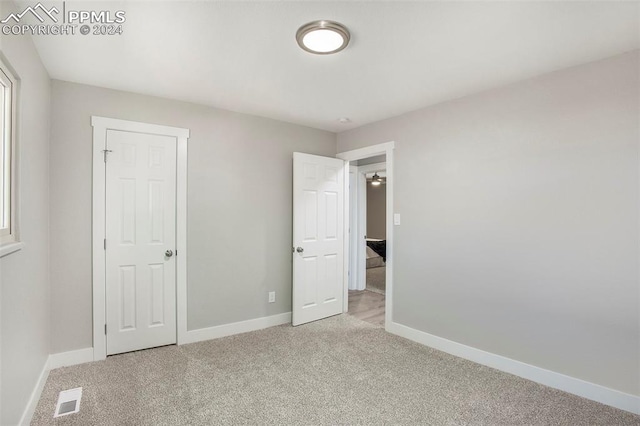 unfurnished bedroom with light colored carpet